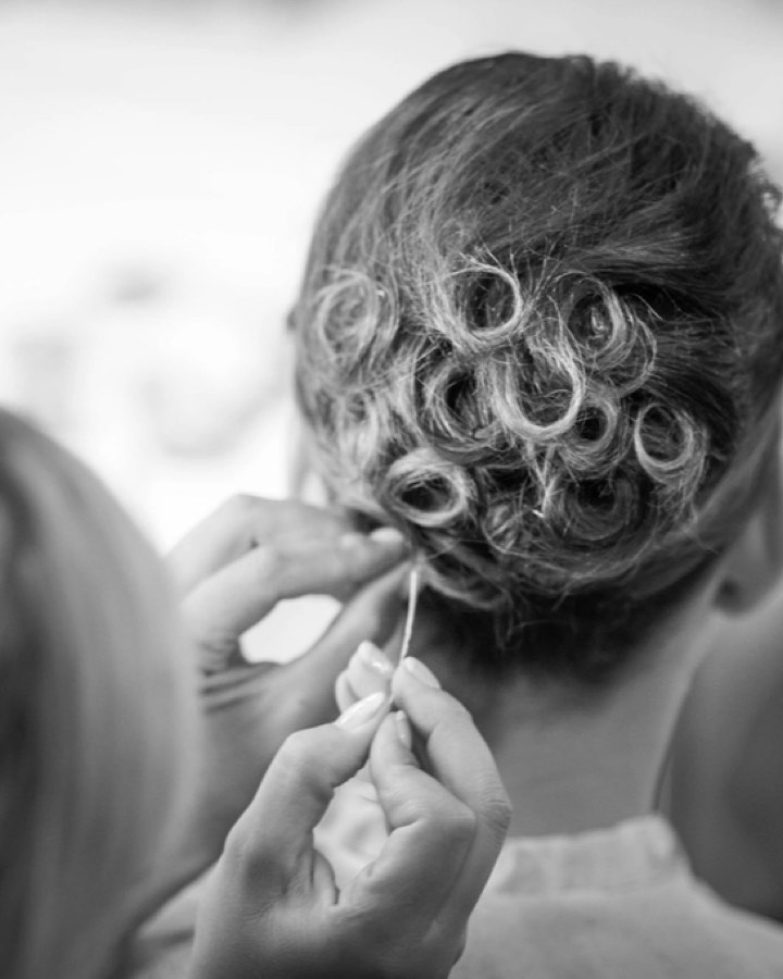 A hairstylist working on a client's hair